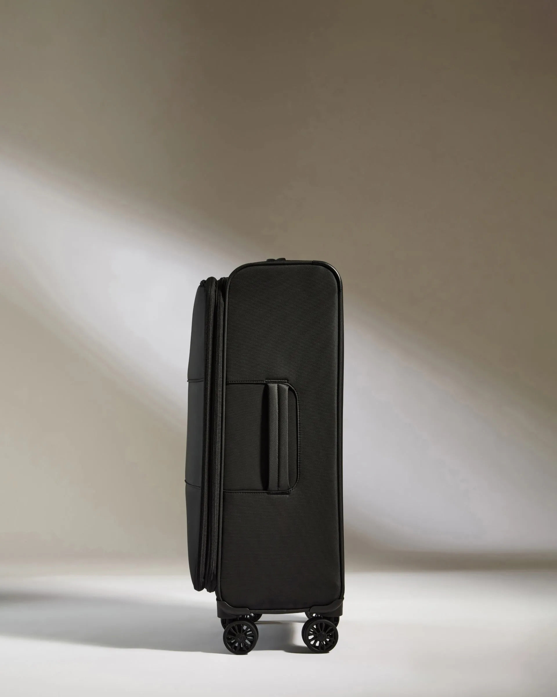 Lightest Medium Luggage in Black - Soft Stripe
